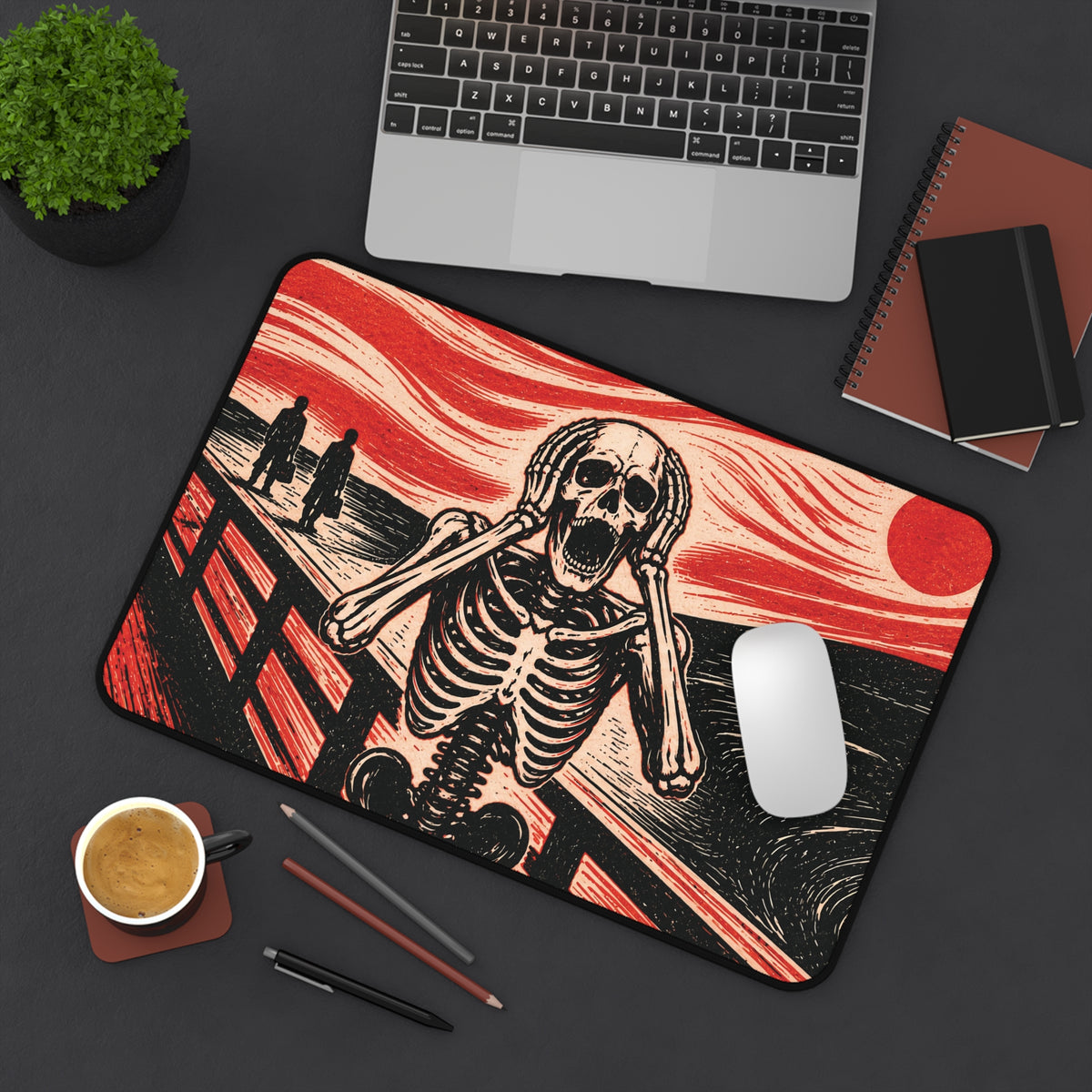 Rectangular desk mat featuring screaming skeleton artwork in red and black with a round moon