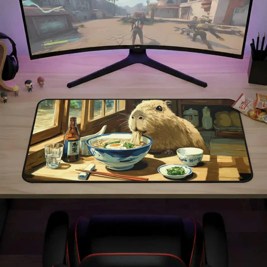 Desk mat with capybara and ramen bowl artwork on a dark rounded rectangle