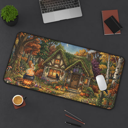 Rectangular desk mat with rounded edges, autumn cottage garden, trees, flowers, and bird silhouette