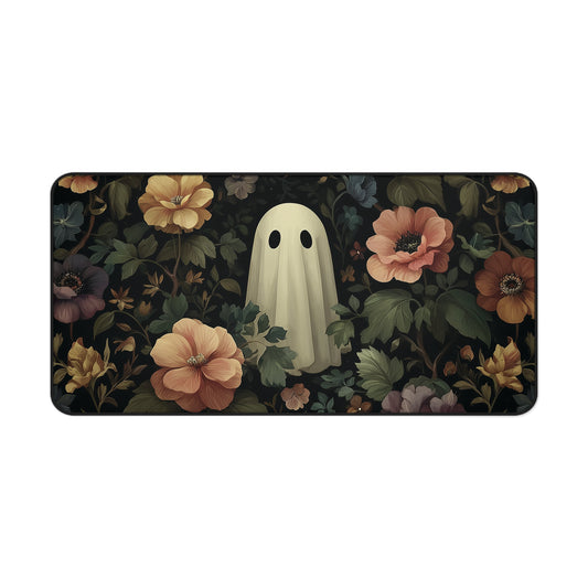 Wide desk mat with centered pale ghost and peach flowers over dark botanical design