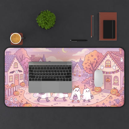 Halloween desk mat featuring kawaii ghosts under night sky with cartoon town houses