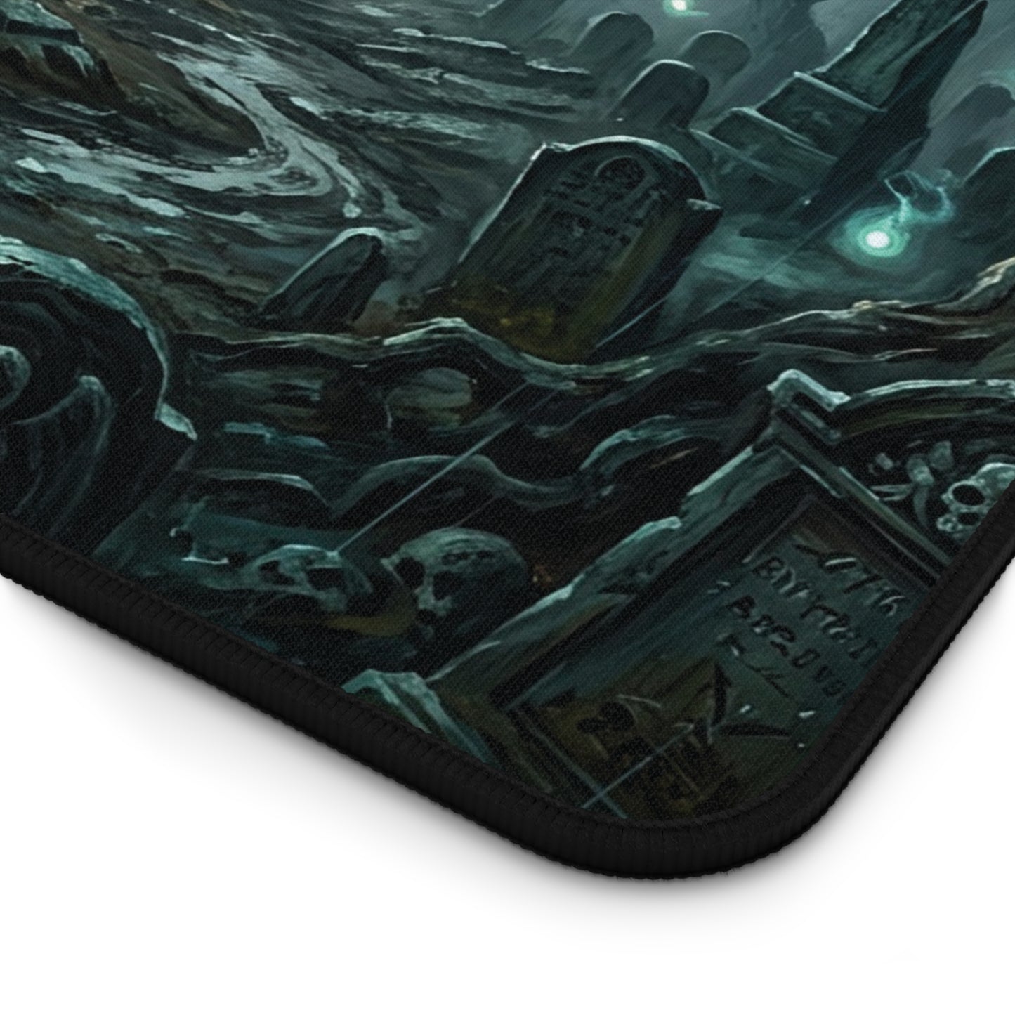Desk mat corner with black stitched edge and dark teal cemetery graphic print