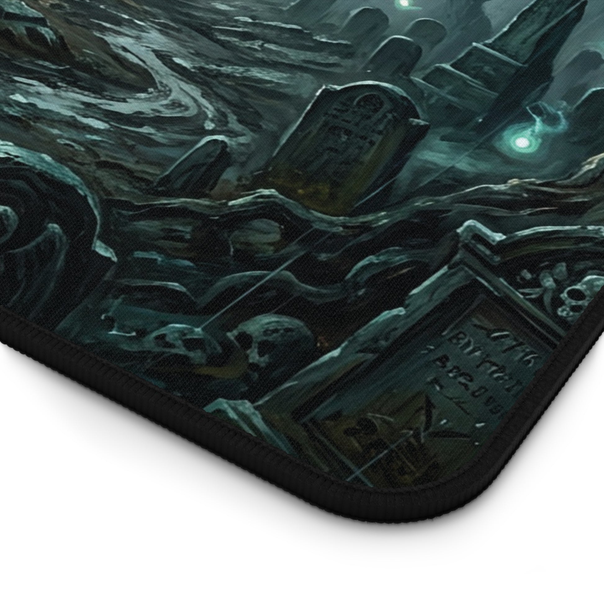 Desk mat corner with black stitched edge and dark teal cemetery graphic print