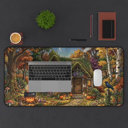 Desk mat showing witch cottage doorway, glowing cauldron, moon sky, and winding forest plants