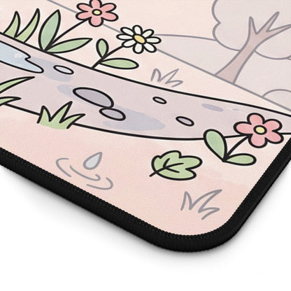 Close-up of pastel printed desk mat corner with raindrops, leaves, flowers, and black trim