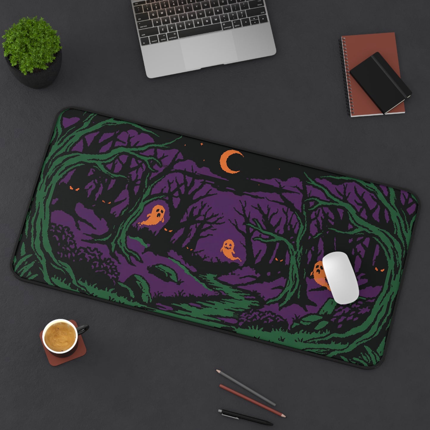 Halloween forest desk mat in purple and green with glowing orange eyes and crescent moon