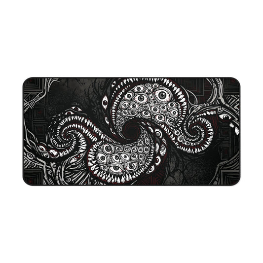 Black desk mat with white tentacle eye illustration, rounded corners and stitched border