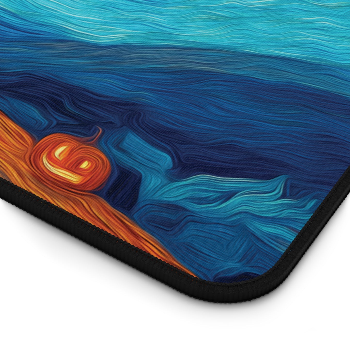 A close-up of a mouse pad with a black border, featuring an abstract, swirling art print in shades of blue, teal, and orange on a white background.