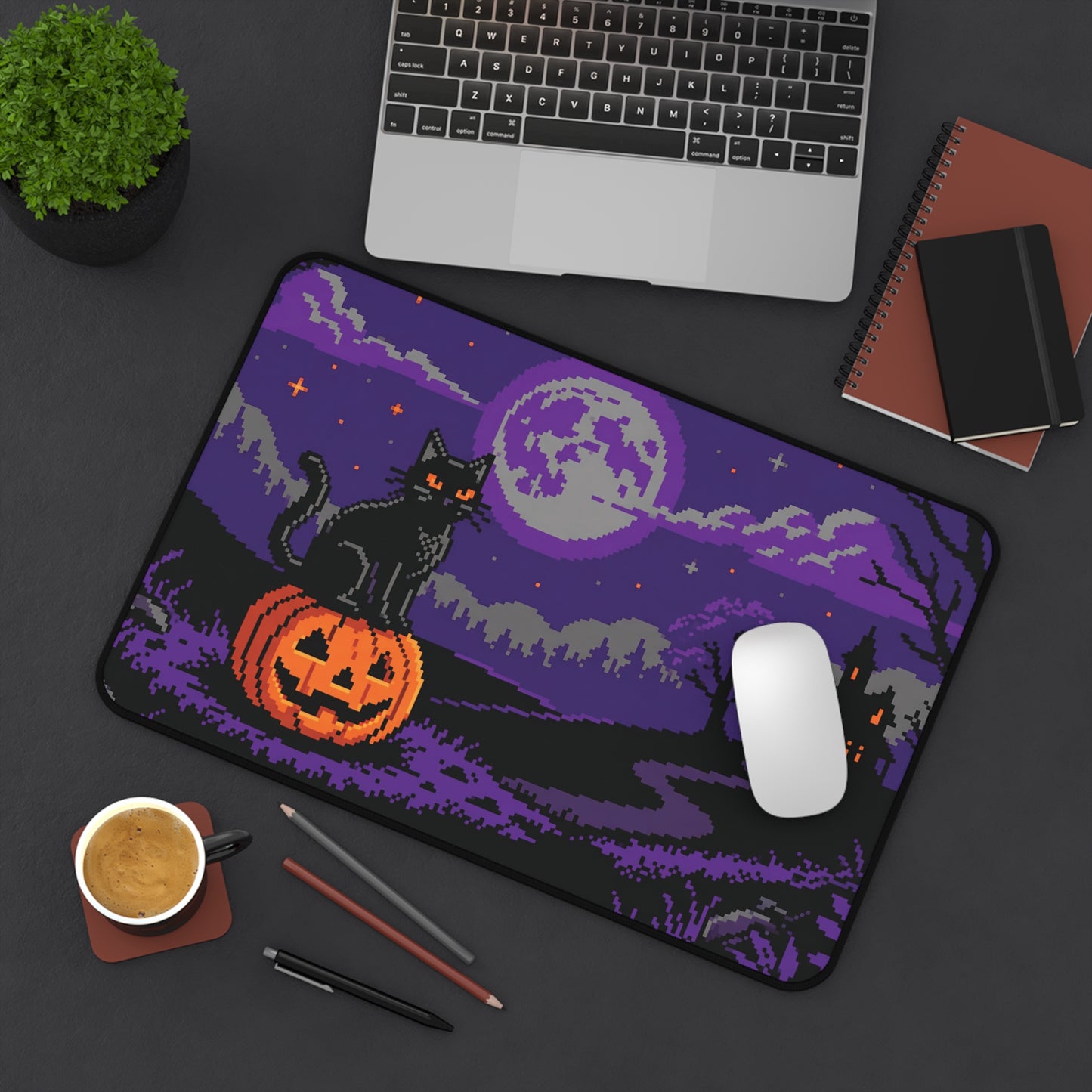 Rectangular desk mat featuring purple pixel art landscape with black cat and orange pumpkin