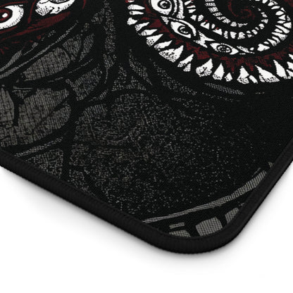 Corner detail of black desk mat with white tentacle pattern and black stitched edge