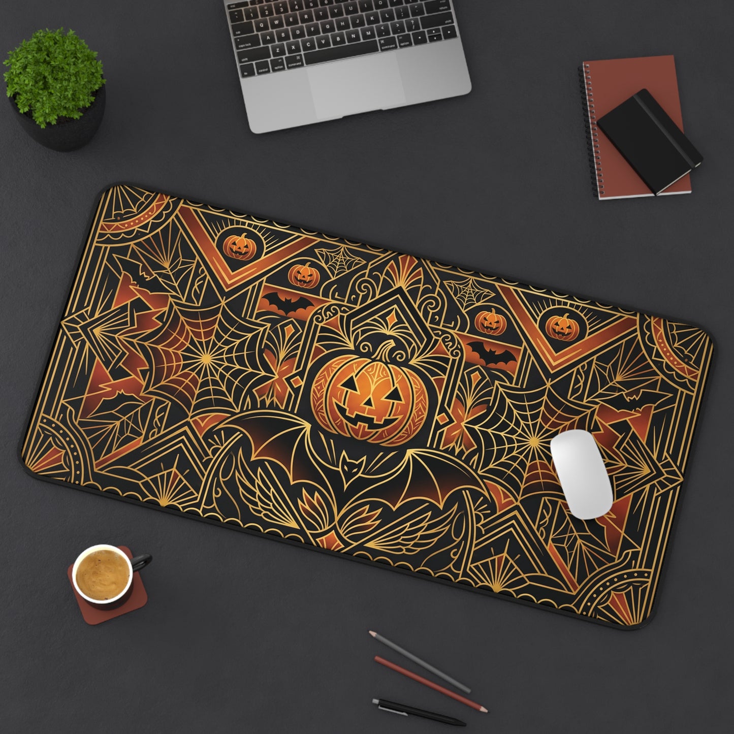 Long rectangular desk mat with gold pumpkin, spiderweb, and geometric art deco pattern