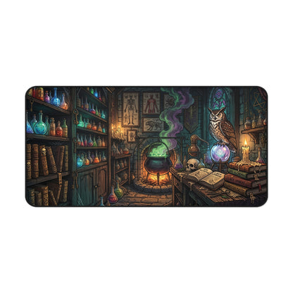 A rectangular desk mat featuring a detailed fantasy illustration of a witch's laboratory with a cauldron, glowing potions, candles, an owl, and an open book, shown on a plain white background.