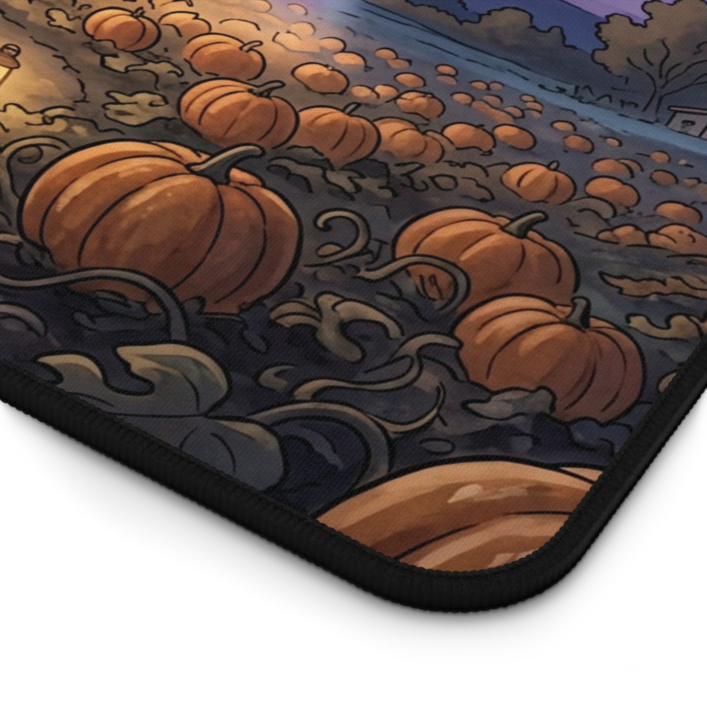 A close-up of a printed mouse pad or desk mat showing an illustrated pumpkin patch scene with orange pumpkins, dark stems, and a night sky, photographed on a white background.