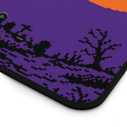 Close-up of purple pixel art desk mat with black stitched edge and haunted pattern