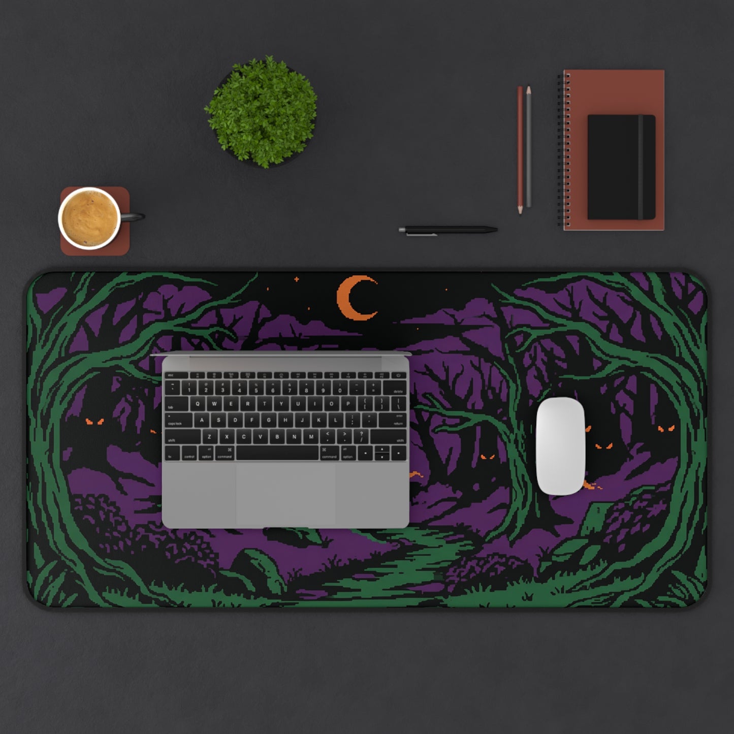 Halloween forest desk mat showing purple-and-green trees, crescent moon, and orange eyes