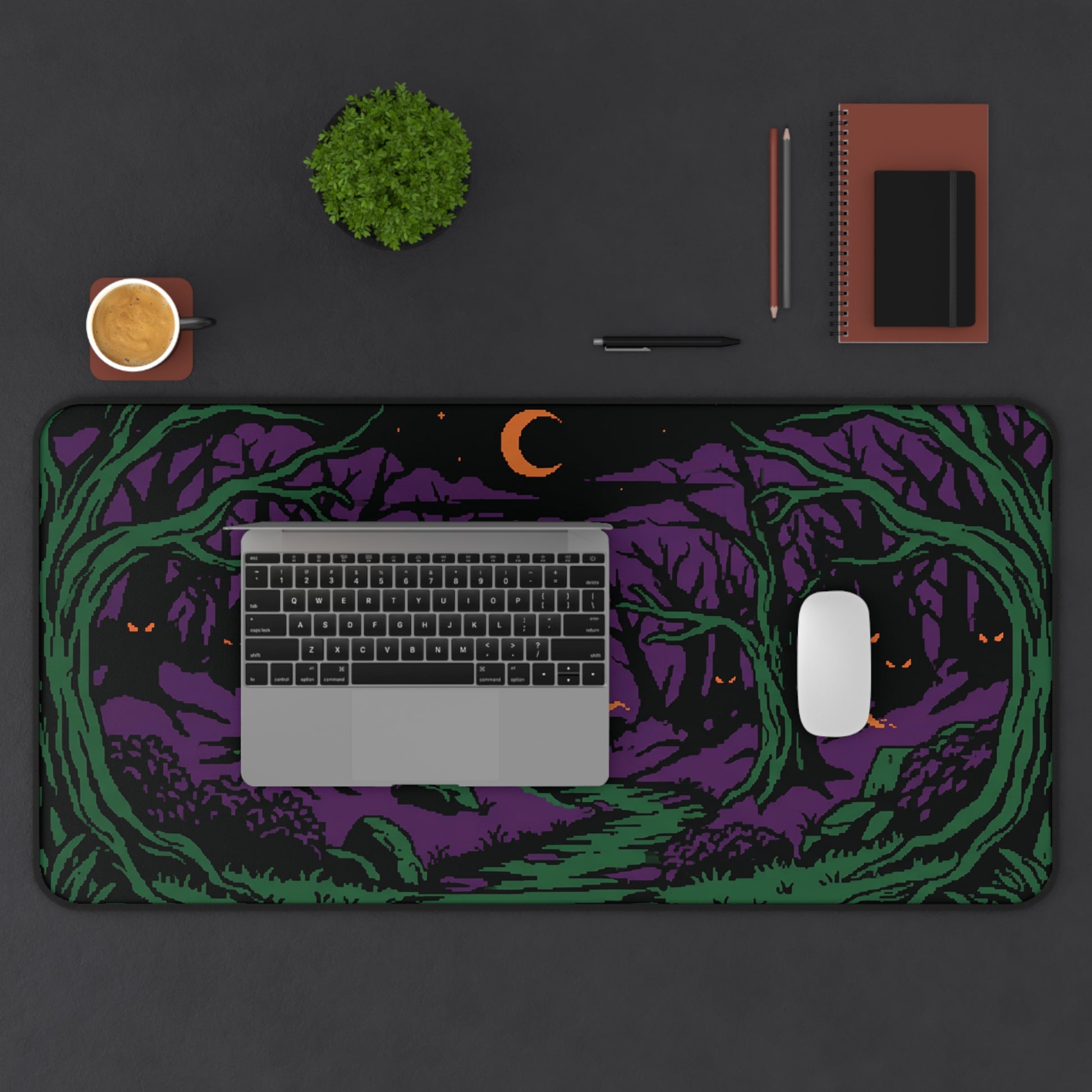Halloween forest desk mat showing purple-and-green trees, crescent moon, and orange eyes