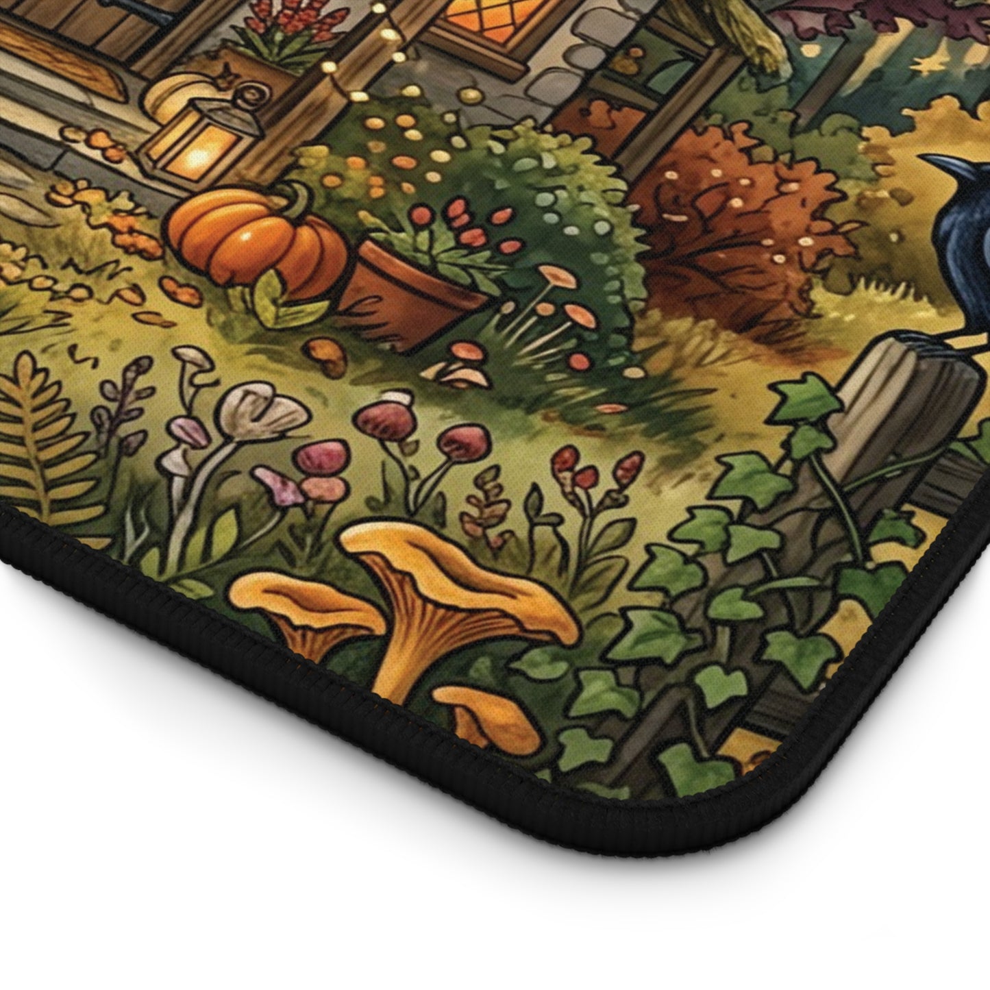 Close-up desk mat corner with black stitched border and printed pumpkins, leaves, and forest shrubs