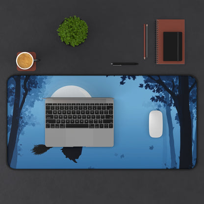 Rectangular blue desk mat with flying witch silhouette, moon design, and black trim
