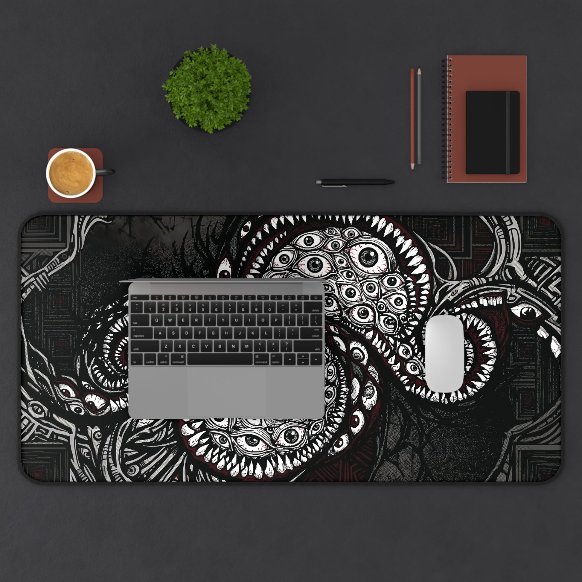 Desk mat with cosmic tentacle and eye design, rounded corners and stitched border