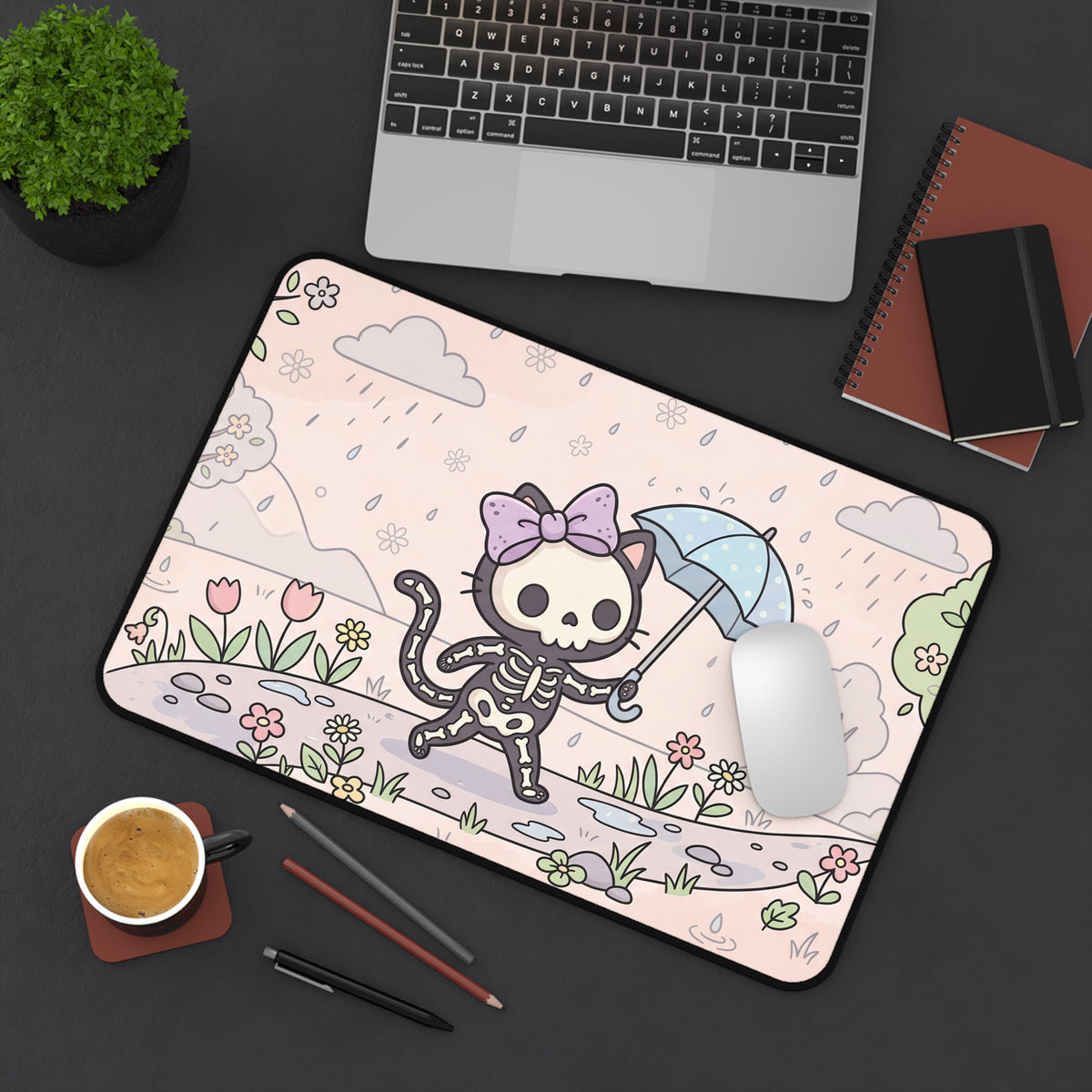Skeleton cat desk mat on office setup, umbrella cat over pink floral landscape with plants