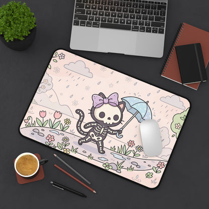 Skeleton cat desk mat on office setup, umbrella cat over pink floral landscape with plants