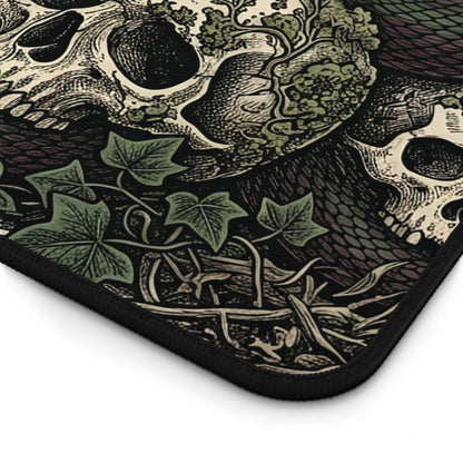 Close-up of dark gothic desk mat corner with skull, snake scales, leaves, and stitched edge