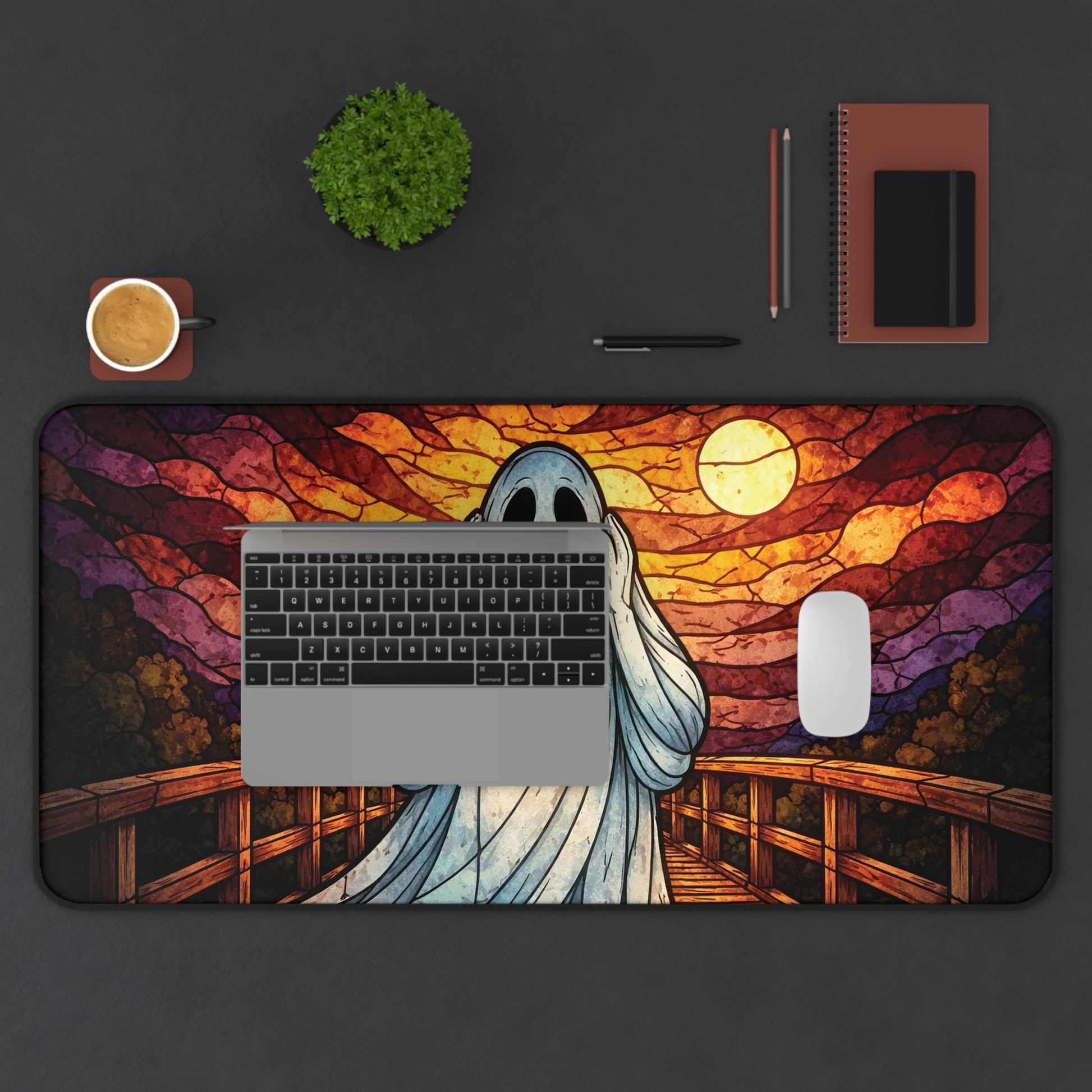 Halloween ghost desk mat with blue ghost face and stained-glass sunset bridge mural