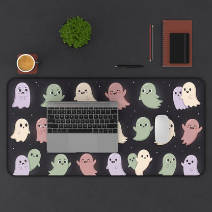 Pastel ghost pattern desk mat covering a laptop area, rounded edges