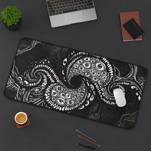 Black desk mat with white and red cosmic tentacle eye design, stitched edge