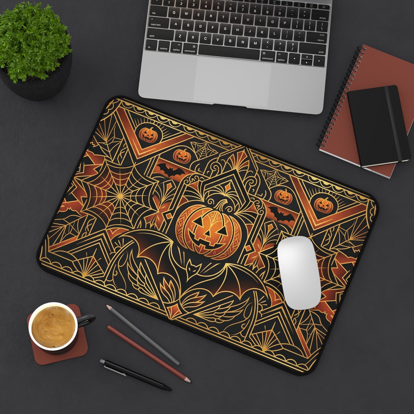 Rectangular desk mat with gold art deco pumpkin and spiderweb pattern on black